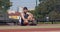 Young bearded guy texting on smartphone at outdoor basketball court