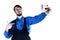 A young bearded guy in a work uniform makes a selfie on a modern smartphone, pointing to himself with his finger