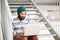 Young bearded hipster student using computer outdoors