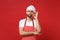 Young bearded male chef cook or baker man in striped apron white t-shirt toque chefs hat posing isolated on red