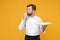 Young bearded male chef cook or baker man in white uniform shirt posing isolated on yellow wall background. Cooking food