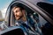 Young bearded male passenger looking out the window of a car. Travel, lifestyle, transport concept