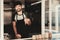 Young Bearded Man in Apron Standing in Food Truck.