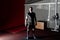 Young bearded man in gym after training. Full body length portrait.