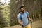 Young bearded man hiking alone on mountain