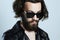 Young bearded man in a leather. Hipster in sunglasses