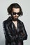 Young bearded man in leather. Hipster in sunglasses