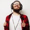 young bearded man listening to music