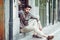 Young bearded man, model of fashion, sitting in an urban step we