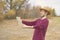 Young bearded man in summer hat lost in the forest and search the road on map f