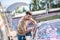 Young bearded man wiping car glass