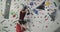 Young bearded muscular athlete falling down from a climbing wall