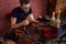 Young bearded shoemaker making an unusual pattern in the insoles