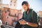 Young bearded traveller using his smartphone