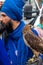 Young bearded warrior of the Sikh monotheism religion in procession with a hawk