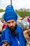 Young bearded warrior of the Sikh monotheism religion in procession with a hawk