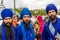 Young bearded warriors of the Sikh monotheism religion in procession with a hawk