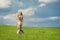 Young beatiful girl in green field