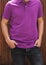 Young beatiful male model in purple polo T-shirt and dark black