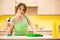 The young beatifull woman polishing table in the kitchen