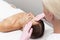 Young beautician or dermatologist doing manual facial cleansing for a woman in a beauty salon. Spa facial massage