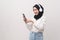 Young beautifu muslim woman wearing headset on white background