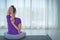 Young  beautifu woman sitting in a yoga room