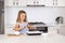 Young beautiful and adorable girl 6 or 7 years old cooking and baking at home kitchen preparing chocholate cake smiling happy and