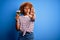 Young beautiful African American afro woman with curly hair on vacation drinking glass of beer with open hand doing stop sign with