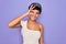 Young beautiful african american afro woman wearing tiara crown over purple background doing ok gesture with hand smiling, eye