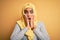 Young beautiful african american girl wearing muslim hijab over isolated yellow background afraid and shocked, surprise and amazed