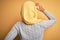 Young beautiful african american girl wearing muslim hijab over isolated yellow background Backwards thinking about doubt with