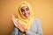 Young beautiful african american girl wearing muslim hijab over isolated yellow background clapping and applauding happy and