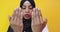Young beautiful African American girl wearing Muslim hijab over isolated yellow background praying with hands together
