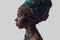 Young beautiful African woman in traditional style with scarf, earrings crying, isolated on gray background.