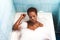 Young and beautiful Afro American woman takes a bubble bath in the bathtub. Beauty and hygiene concept