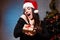 Young beautiful amazed happy woman in evening dress and Santa ca