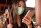 Young beautiful Asian Chinese student woman at airport wearing protective facial mask checking news and information with mobile