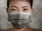 Young beautiful Asian Chinese woman in protective face mask in prevention against Wuhan Coronavirus epidemic outbreak in China in