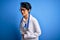 Young beautiful asian doctor girl wearing stethoscope and coat with blue cancer ribbon with hand on stomach because indigestion,