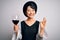 Young beautiful asian sommelier girl drinking glass of red wine over isolated white background doing ok sign with fingers,