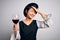 Young beautiful asian sommelier girl drinking glass of red wine over isolated white background stressed with hand on head, shocked