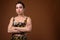 Young beautiful Asian transgender woman against brown background