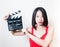 Young beautiful asian woman holding clapperboard white background