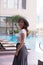 Young beautiful Asian woman standing near swimming pool. Summer concept