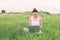 Young beautiful asian woman using Laptop on nature meadows.