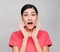 Young beautiful asian woman wore pink t shirt, Showed surprised  expression , on gray background