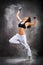 Young beautiful athletic woman dancing modern dance hip-hop