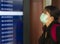 Young beautiful and attractive Asian Chinese student at airport wearing protective facial mask against China Coronavirus epidemic