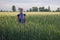 Young beautiful babywearing mother carry her newborn baby in a ring sling in rural field scene